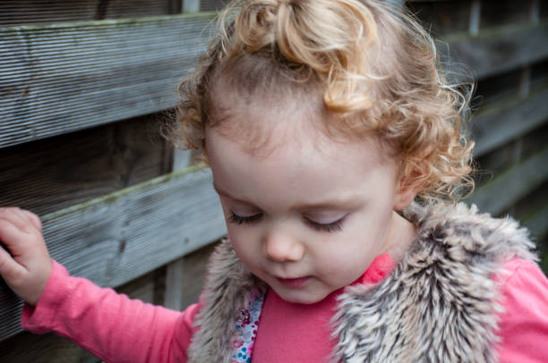 istock Little Girl Looking Down 909538526