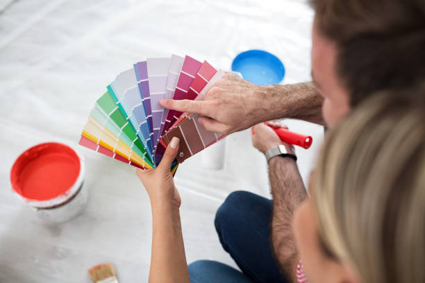 Young happy couple choosing colors Young happy couple choosing colors for painting their home 2000 photos stock pictures, royalty-free photos & images