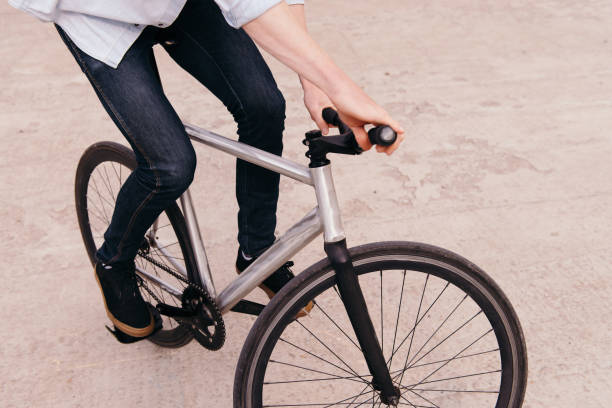 istock Stylish young man riding his fix bike. 909543138