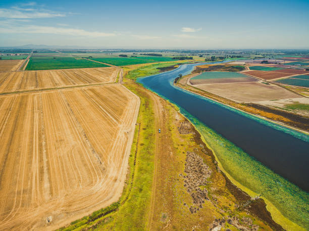 istock Aerial view of Werribee river flowing among fields, meadows and pastures on bright summer day 909545452