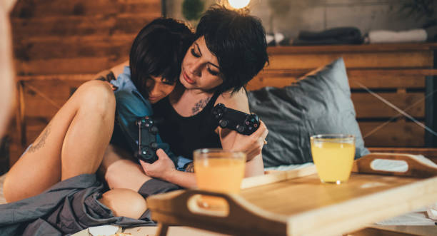 istock Women playing video game 909545818