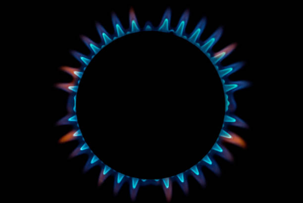 Gas Supply Flame A bright neon blue flame emitting from a cooker hob. gas stove burner photos stock pictures, royalty-free photos & images