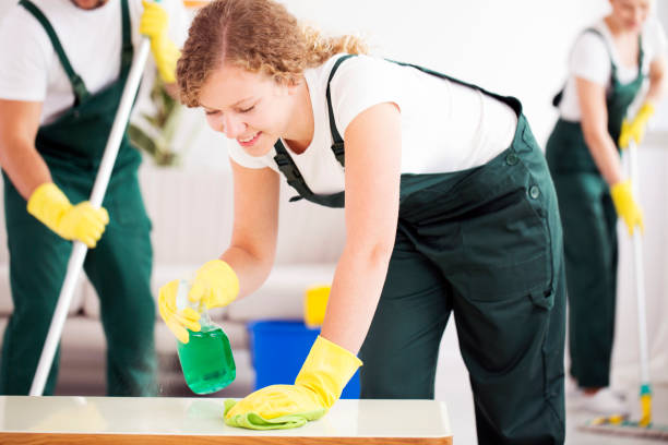 istock Young woman cleaning the table 909550138