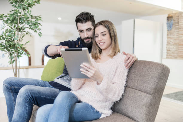 istock Young couple looking tablet at home 909551158