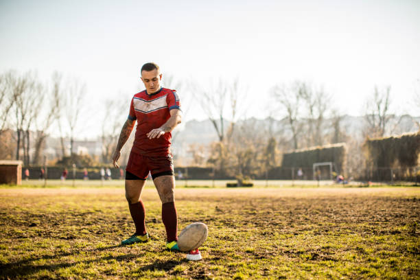 istock Kicking the ball on a rugby field 909554164