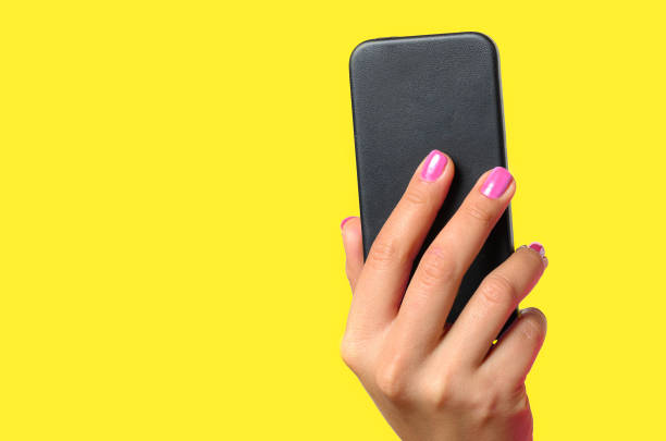 istock Young woman holding a mobile phone 909562038