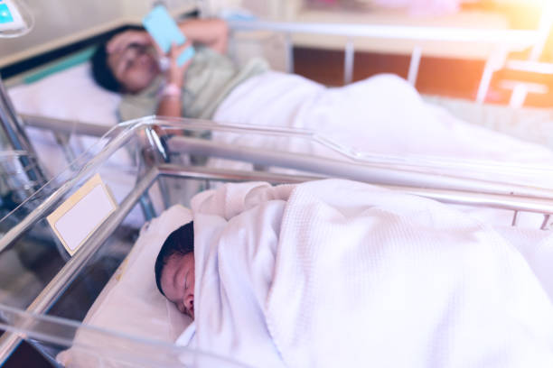istock A newborn infant and mother . 909565320
