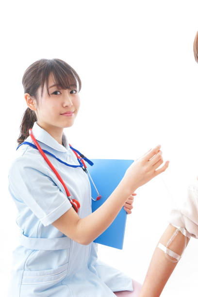 istock Nurse putting woman on a drip 909569572