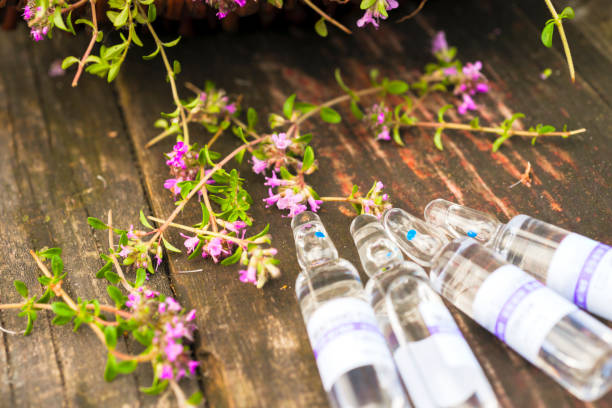 istock Alternative Medicine.Thyme and medical ampoules. Essential oils 909572534