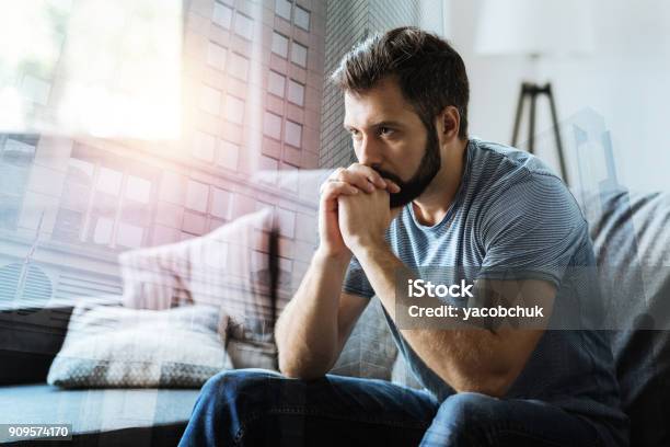 Thoughtful Serious Man Sitting And Thinking Stock Photo - Download Image Now - Men, Anxiety, Addiction