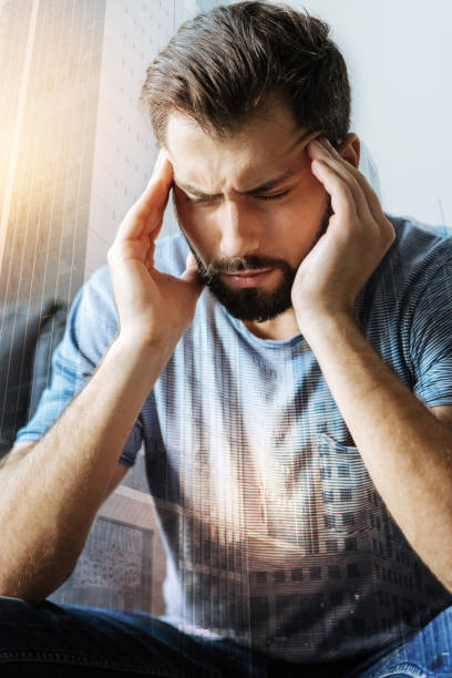 istock Sick troubled man sitting and having head ache 909574368