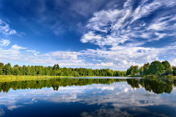 istock Lake landscape with beautiful reflection of a sky 909575632