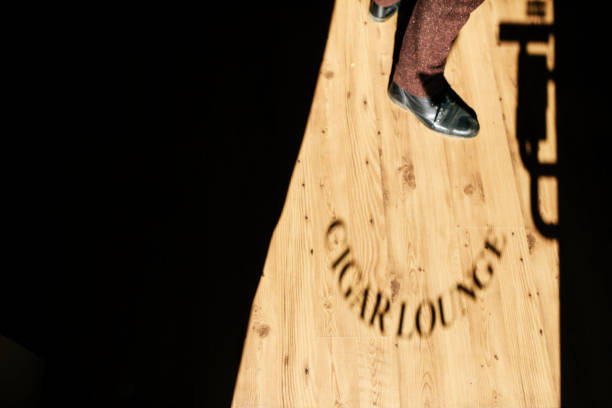 istock Shadow Cast By Cigar Lounge Sign Through Window 909578724