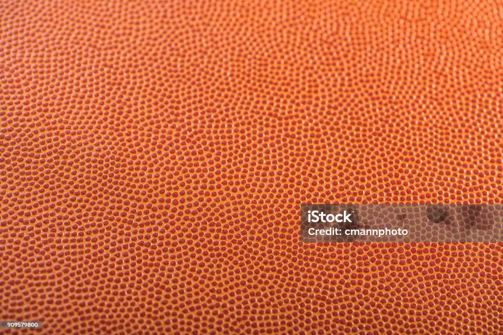 Basketball textured background with selective focus A close-up with selective focus on a basketball's pebbled textured. Basketball - Sport Stock Photo