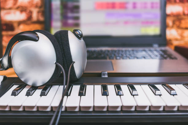istock headphone on midi keyboard. computer music. home studio concept 909582214