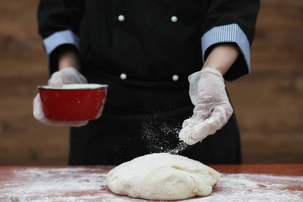 istock the cook makes flour for baking on the table 909585944