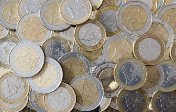istock lots of Euro coins on spread flat surface 909586506