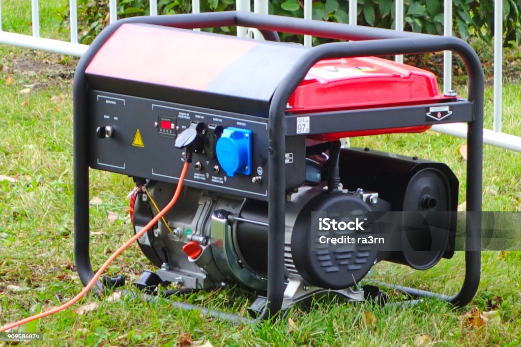 Portable power generator Working portable electric generator on green grass Generator Stock Photo