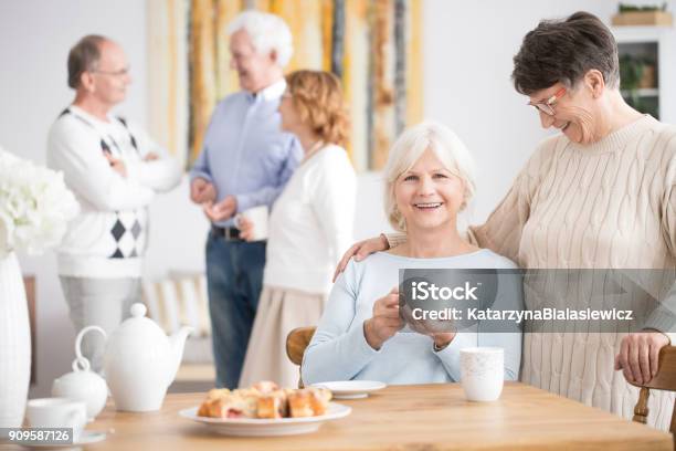 Elderly Woman And Smiling Friend Stock Photo - Download Image Now - Retirement Community, 70-79 Years, Domestic Life