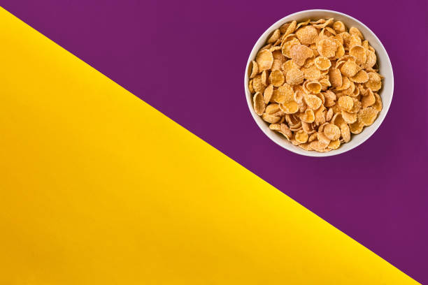 istock Bowl with cornflakes on the colorful background 909597816