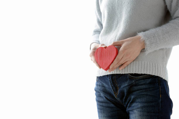 istock Woman havinbg herat shape on lower stocmach 909605802