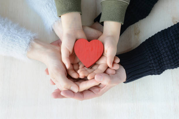 istock Heart in famiy hands 909605878