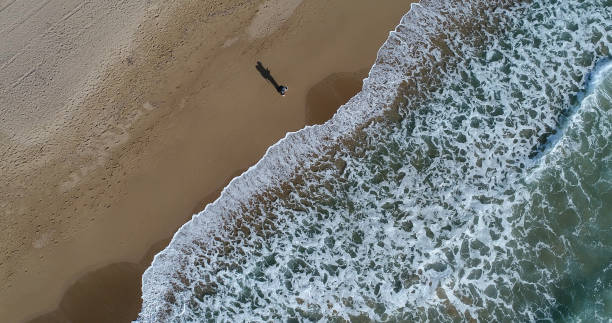 istock Aerial view of the men using drone at beach 909606154