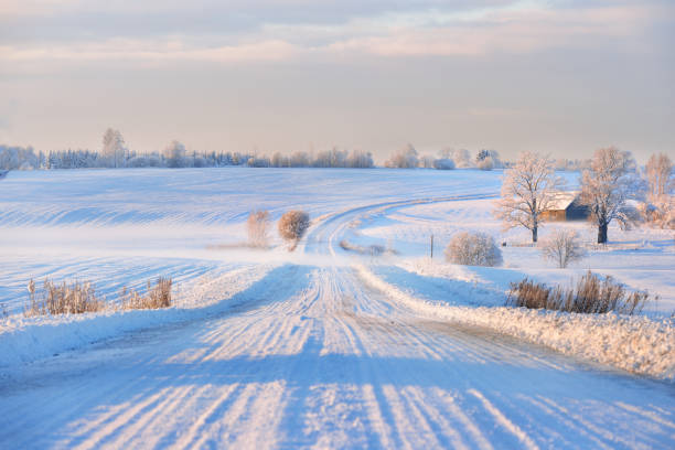 istock Fog over a snowcovered rural highway during winter sunset 909609060