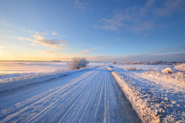 istock Snowcovered rural highway during winter sunset 909609092