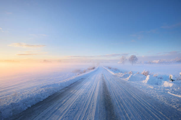 istock Fog over a snowcovered rural highway during winter sunset 909609100
