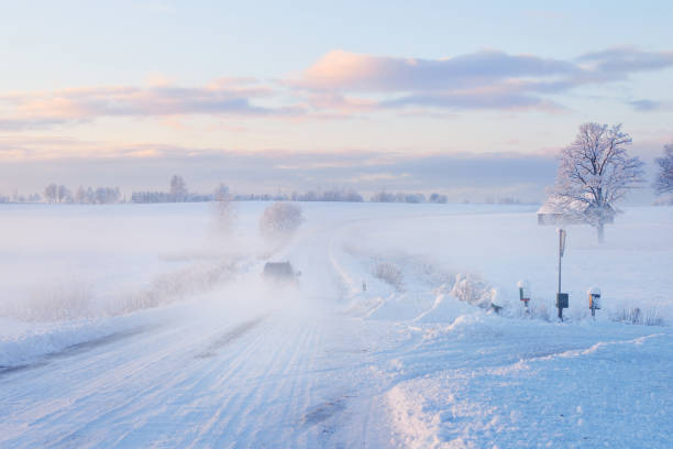istock Fog over a snowcovered rural highway during winter sunset 909609128