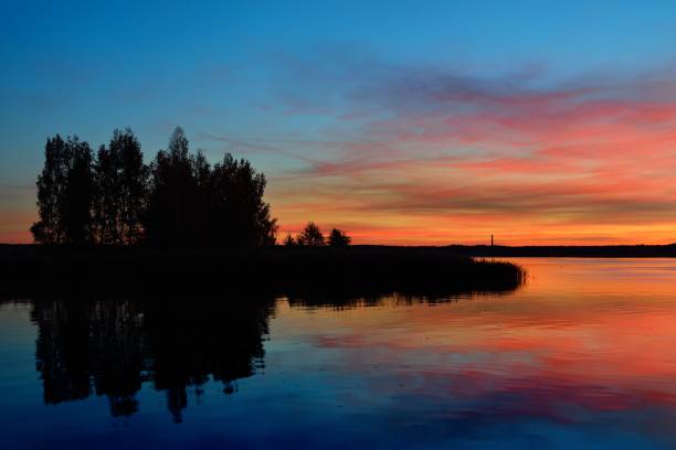 istock Colorful sunrise on a lake 909614412