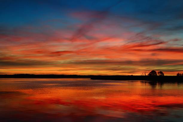 istock Colorful sunrise on a lake 909614422