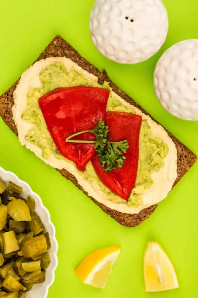 Photo of Red Peppers With Avocado and Hummus On Rye