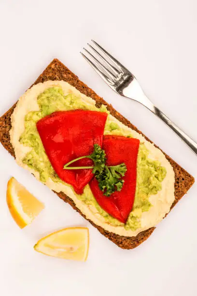 Photo of Red Peppers With Avocado and Hummus On Rye Open Face Sandwich