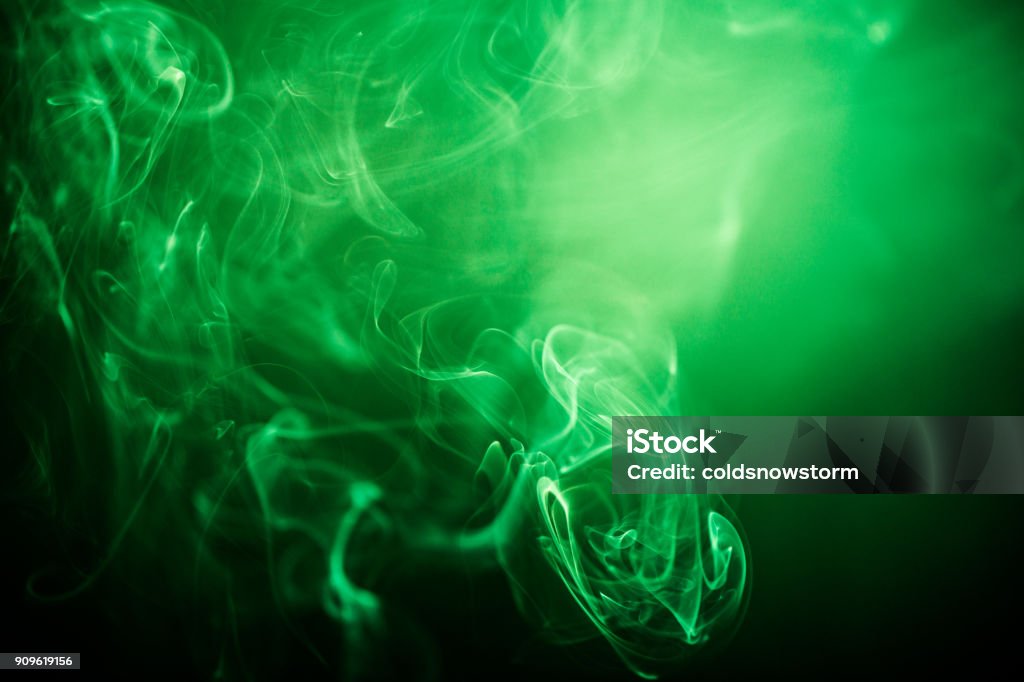 Green swirling smoke abstract close up on black background Close up abstract color image depicting green-colored smoke swirling around on a black background. Plenty of room for copy space. Green Color Stock Photo