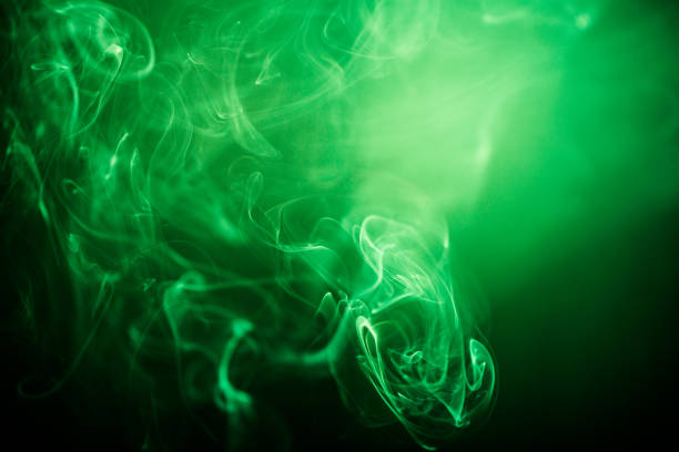 green swirling smoke abstract close up on black background - toxic substance smoke abstract green imagens e fotografias de stock