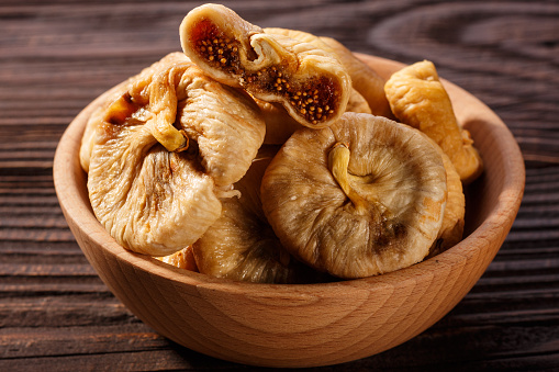 Dried figs on a dark rustic background.