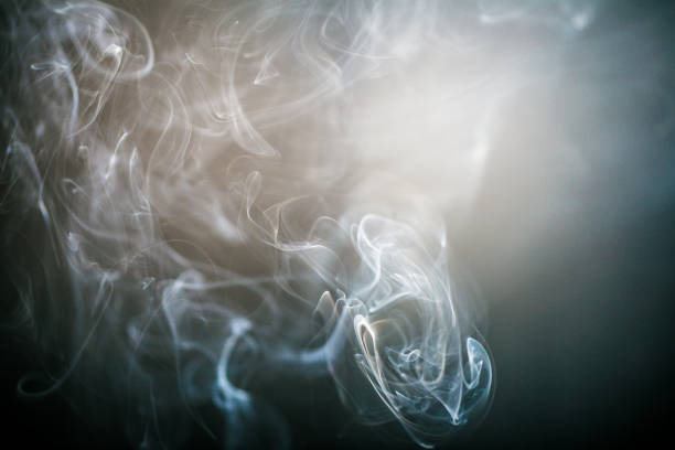 istock Blue swirling smoke abstract close up on black background 909622720