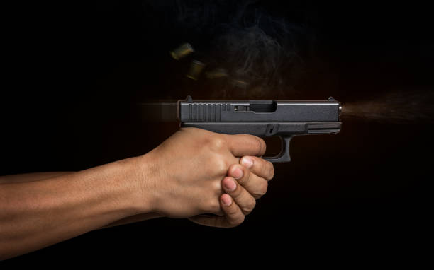 Hand gun automatic pistole Man hand holding on the automatic pistole gun in shooting action gun mafia handgun bullet stock pictures, royalty-free photos & images