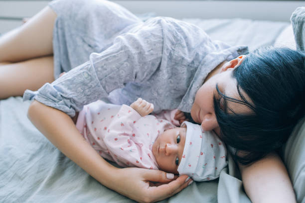 istock a mother's daytime sleep with her newborn baby 909629682