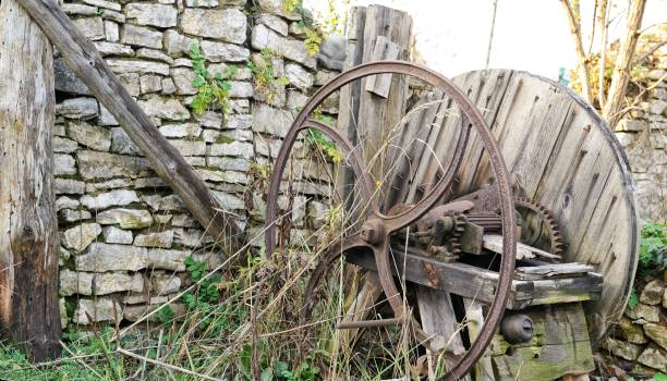 istock Old wooden chaff cutter standing on grass 909635574