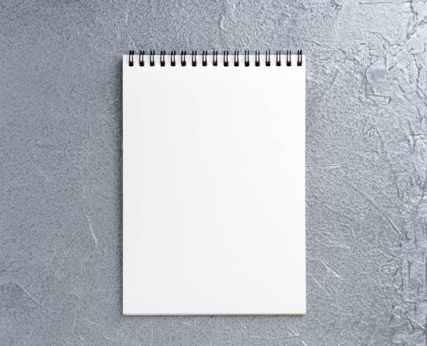 istock blank sheet of notebook with a spiral on a neutral gray textured silver metallic background 909638436