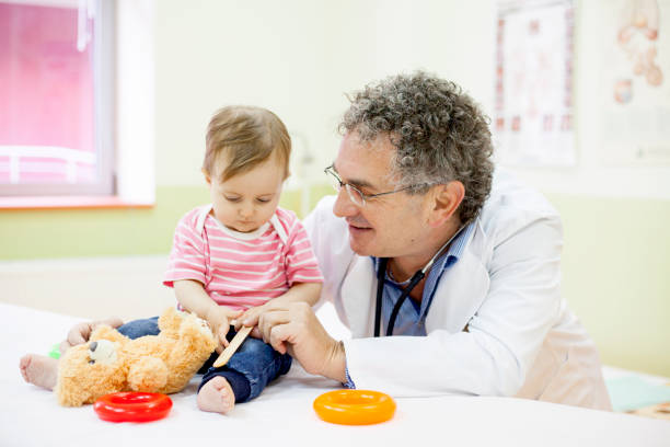 istock Pediatrician with baby 909639744