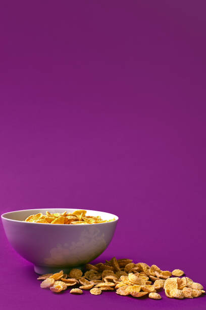 istock Bowl with cornflakes on the colorful background 909642108