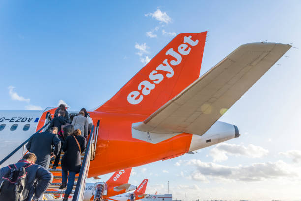 Passengers board an Easyjet airplane at London's Gatwick airport stock photo