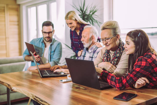 istock Young volunteers help senior people on the computer 909664254