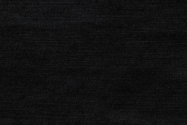 Black background, denim jeans background. Jeans texture, fabric.