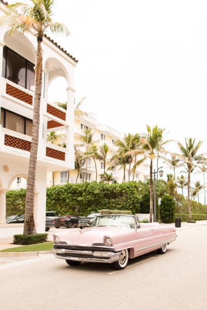 istock Light Pink Vintage Car Driving Down Worth Avenue 909674790