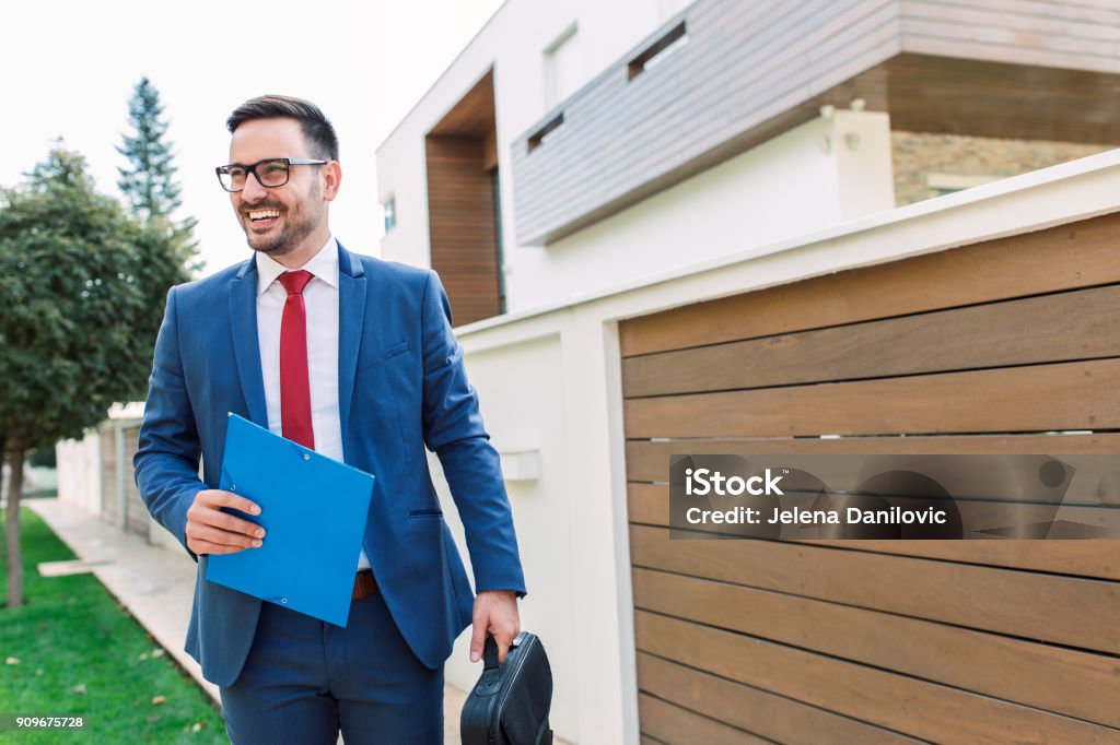 Businessman Smiling modern young businessman going to work Real Estate Agent Stock Photo